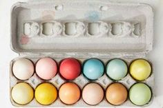 an egg carton filled with different colored eggs