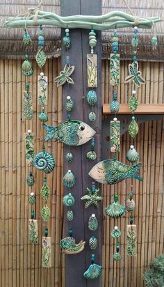 a wall hanging made out of wood with sea shells and seashells on it