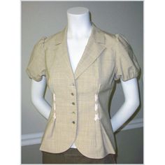 As Seen On Kelly Ripa Material: 96% Wool, 4% Lycra; Lining 100% Silk Fit: Fitted Length: 22 Inches Details: Short Elasticized Puffed Sleeves. Mother Of Pearl Buttons. Smart Cut. Crisscross Cream Ribbon Accents In Front. Fully Lined. Care: Dry Clean Origin: Made In China Color: Flaxseed Classic Fitted Short Sleeve Outerwear, Fitted Short Sleeve Blazer With Buttons, Fitted Single-breasted Top For Office, Fitted Short Sleeve Fall Blazer, Fitted Short Sleeve Blazer For Fall, Pink Jacket Blazer, Clean Origin, Kelly Ripa, Black And White Tweed