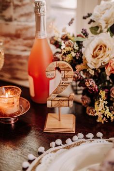 a table topped with candles and wine bottles