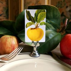 there is a card with an image of a lemon on it next to some apples