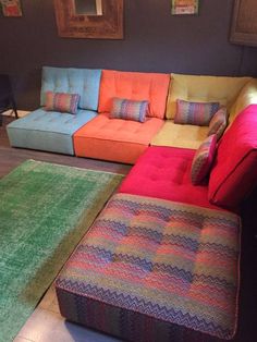 a multicolored couch and ottoman in a living room