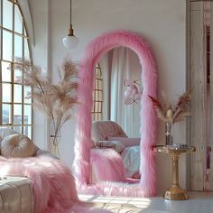 a pink mirror sitting in the middle of a living room next to a white couch