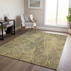 a living room with a chair and rug in front of a large window on the floor