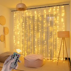 a living room with lights on the curtains and bean bag chair in front of it