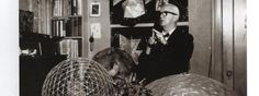 black and white photograph of man in living room