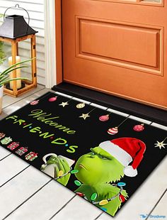 the grinch door mat has been decorated with christmas decorations and santa's hat