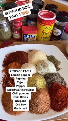 spices on a white plate next to some seasonings and other condiments for cooking