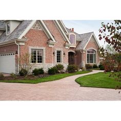 a large brick house with white trim and windows