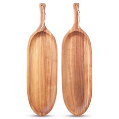 two wooden paddles sitting next to each other