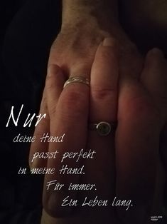 a woman's hand with a ring on it and the words nur written in white