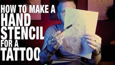 a man holding a piece of paper with the words how to make a hand stencil for a tattoo