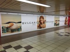 an advertisement for bvlgari is displayed on the side of a subway station