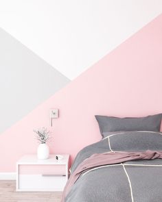 a bedroom with pink and grey wall paint