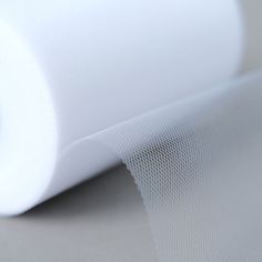 a roll of white mesh sitting on top of a table