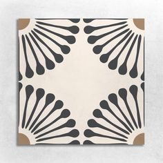 an art deco tile with black and white designs on it's sides, in the shape of fan shapes