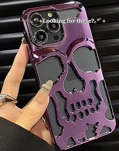 a person holding up a purple case with skulls on it and the words looking for these?