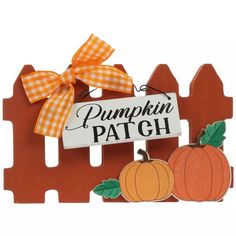 a wooden pumpkin patch sign with a bow on it's head and two small pumpkins