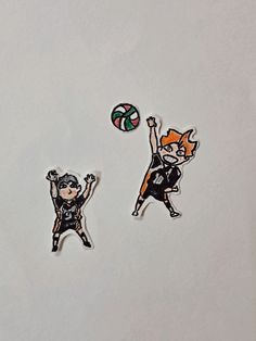 two stickers depicting people playing with a ball on a white surface, one has an orange hair and the other is wearing black