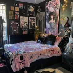 a bed room with a neatly made bed and lots of pictures on the wall