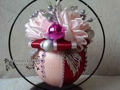 an ornament with pink and white flowers in it