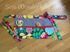 a multicolored purse sitting on top of a wooden floor