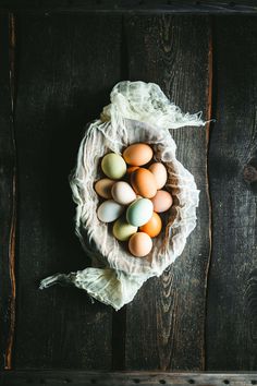 a bunch of eggs sitting in a bag on top of a wooden table