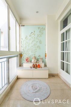 a living room filled with lots of furniture next to a large glass window covered in frosting