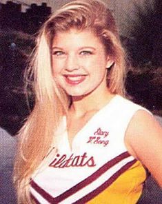 a woman in a cheer uniform posing for a photo