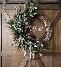 a wreath hanging on the side of a wooden door that says, vintage's treasures