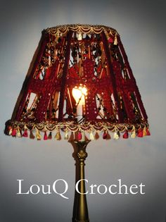 a lamp that is sitting on top of a table with the words louq crochet written below it