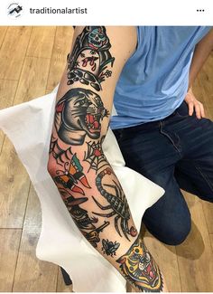 a person sitting on the floor with a tattoo on their arm