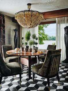 a dining room table with chairs and a chandelier