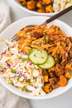 two bowls filled with different types of food on top of a white table cloth next to each other