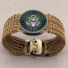 the united states army emblem is on top of a woven bracelet with a metal clasp