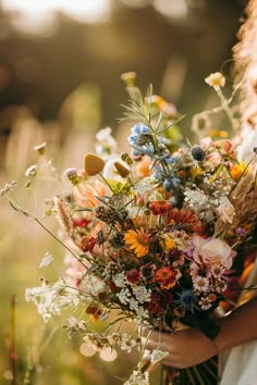 a woman holding a bouquet of flowers in her hands