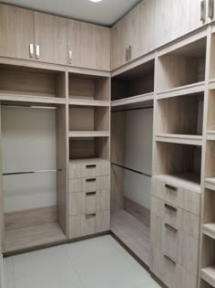 an empty walk in closet with shelves and drawers