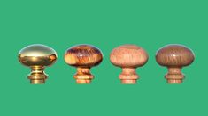 an assortment of wooden knobs on a green background