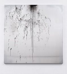 an abstract black and white photograph with water drops on it's surface, hanging from the ceiling