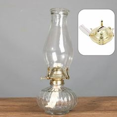 an old fashioned glass oil lamp on a wooden table