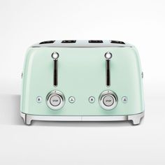 a green toaster sitting on top of a white table