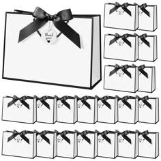 a set of twelve black and white gift bags with matching tags, each containing a bow