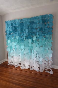 a blue and white wall hanging on the side of a wooden floor