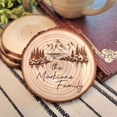 three wooden coasters with the words the markana family engraved on them next to a book