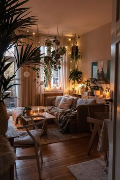 a living room filled with furniture and lots of plants