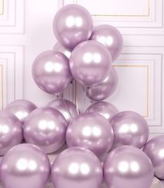 a bunch of purple balloons sitting on top of a table