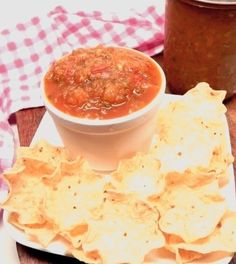 a bowl of chili and tortilla chips on a plate