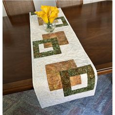 a table runner with yellow flowers in a vase