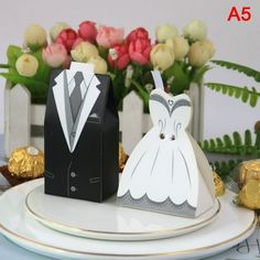 wedding cake toppers on plates with flowers in the background