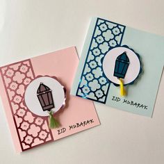 two handmade greeting cards, one with a lantern and the other with a tassel